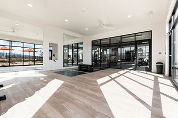 Spacious room with black mat in gym